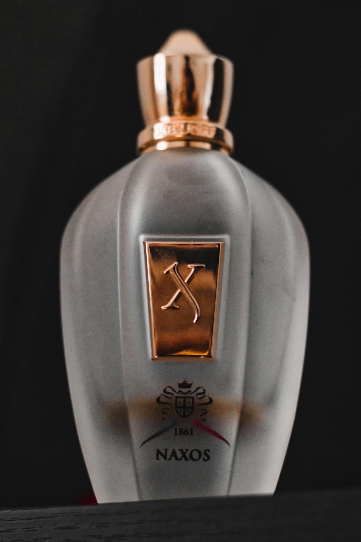 Flacon de parfum de niche minimaliste en verre épais sur fond neutre
